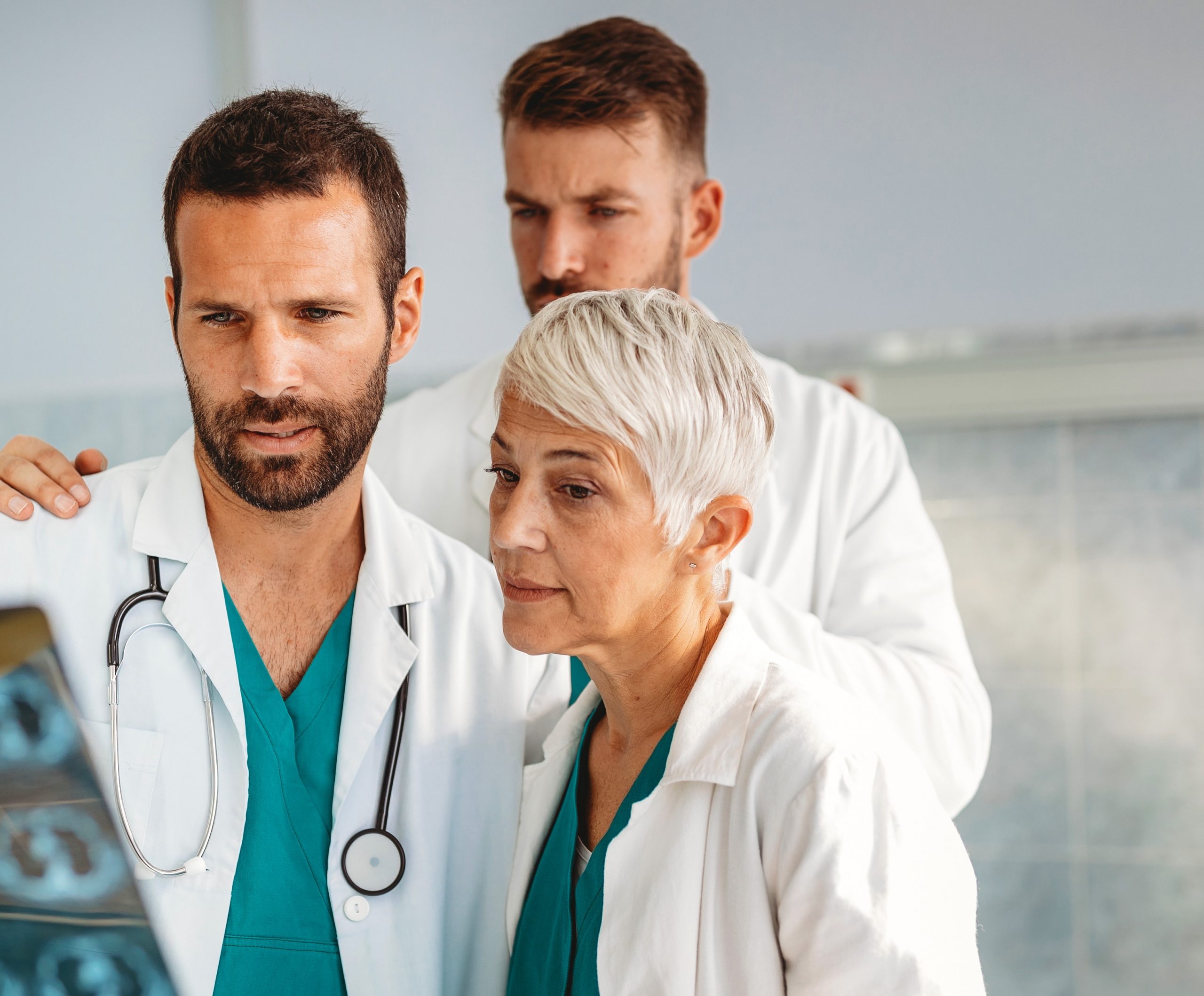 Doctors discussing patient's diagnosis looking at x-rays in a hospital